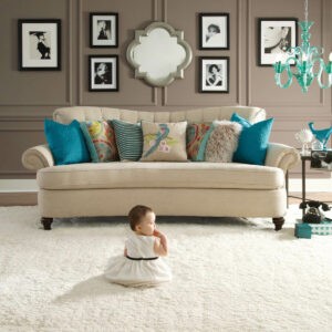 Cute baby sitting on bright carpet | Carpet To Go