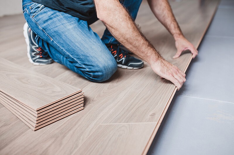 Man installing laminate flooring